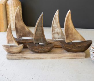 FIVE WOODEN SAIL BOATS ON A BASE