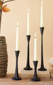 SET OF FOUR CAST IRON TAPER CANDLE HOLDERS