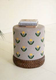 UPHOLSTERED OTTOMAN WITH CARVED WOOD BASE - GREY